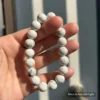 Personalized white dog memorial bracelet with natural stone beads, a keepsake to remember your beloved pet.