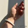 Personalized white dog memorial bracelet with natural stone beads, a keepsake to remember your beloved pet.