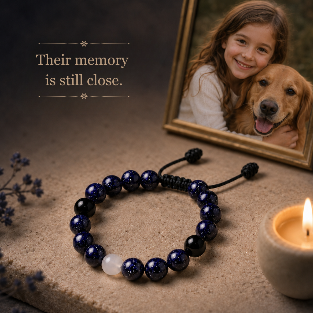Pet memorial bracelet beside a family memory frame for remembering a beloved dog or cat