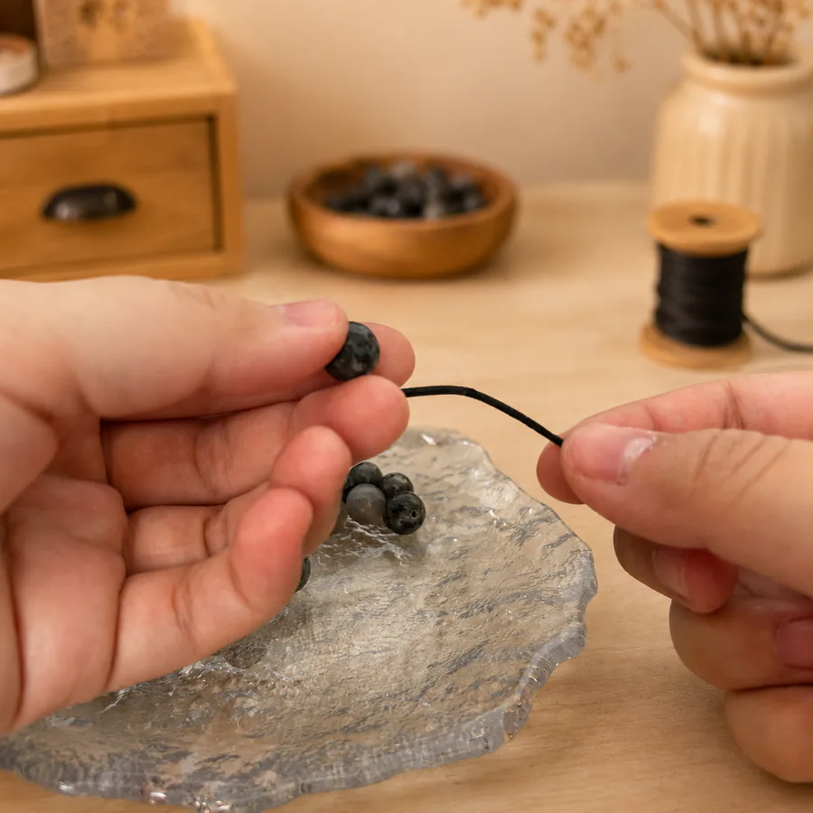 Natural beads being selected by hand for The Return Bracelet
